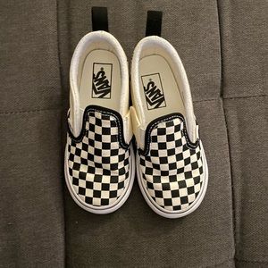 black checkered Vans slip on